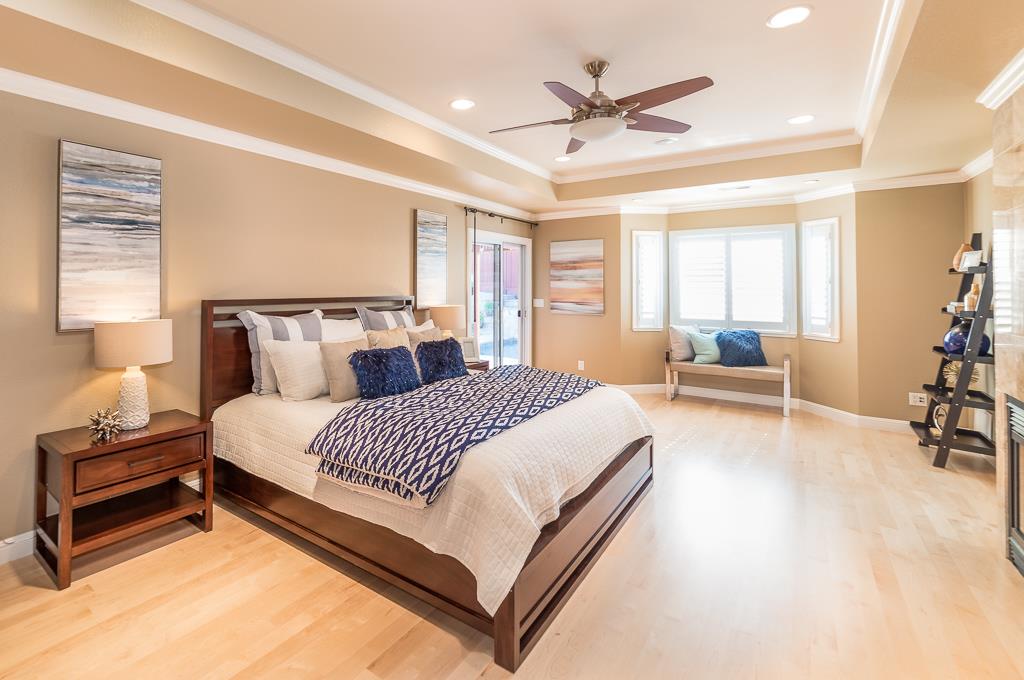 1952 Fallen Leaf Lane Los Altos, CA 94024 - Photo 10 of 23 a spacious bedroom with a bed a table and a chandelier