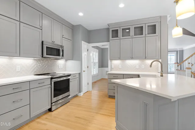 a kitchen with granite countertop a sink and stainless steel appliances