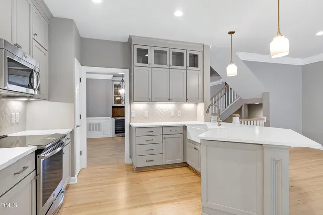 a kitchen with white cabinets and stainless steel appliances