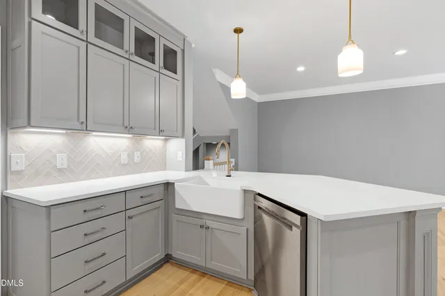 a kitchen with a sink a stove and cabinets