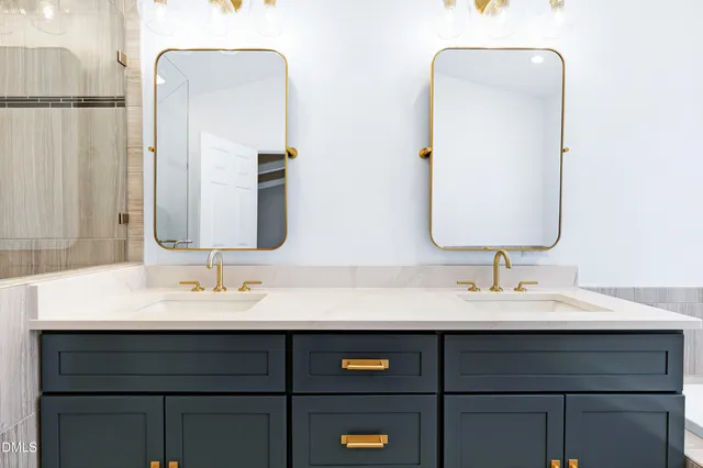 a bathroom with a double vanity sink and mirror