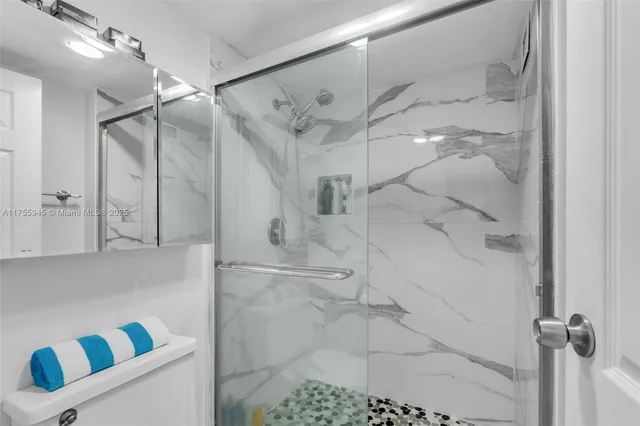 a bathroom with a shower and a shower