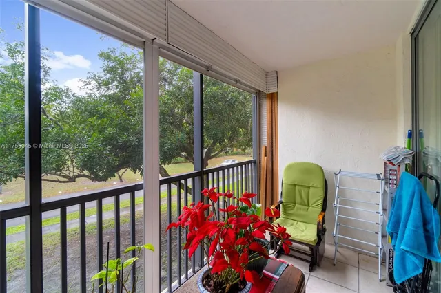 a view of a two chairs in the balcony