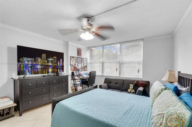 a bedroom with a bed window and a television