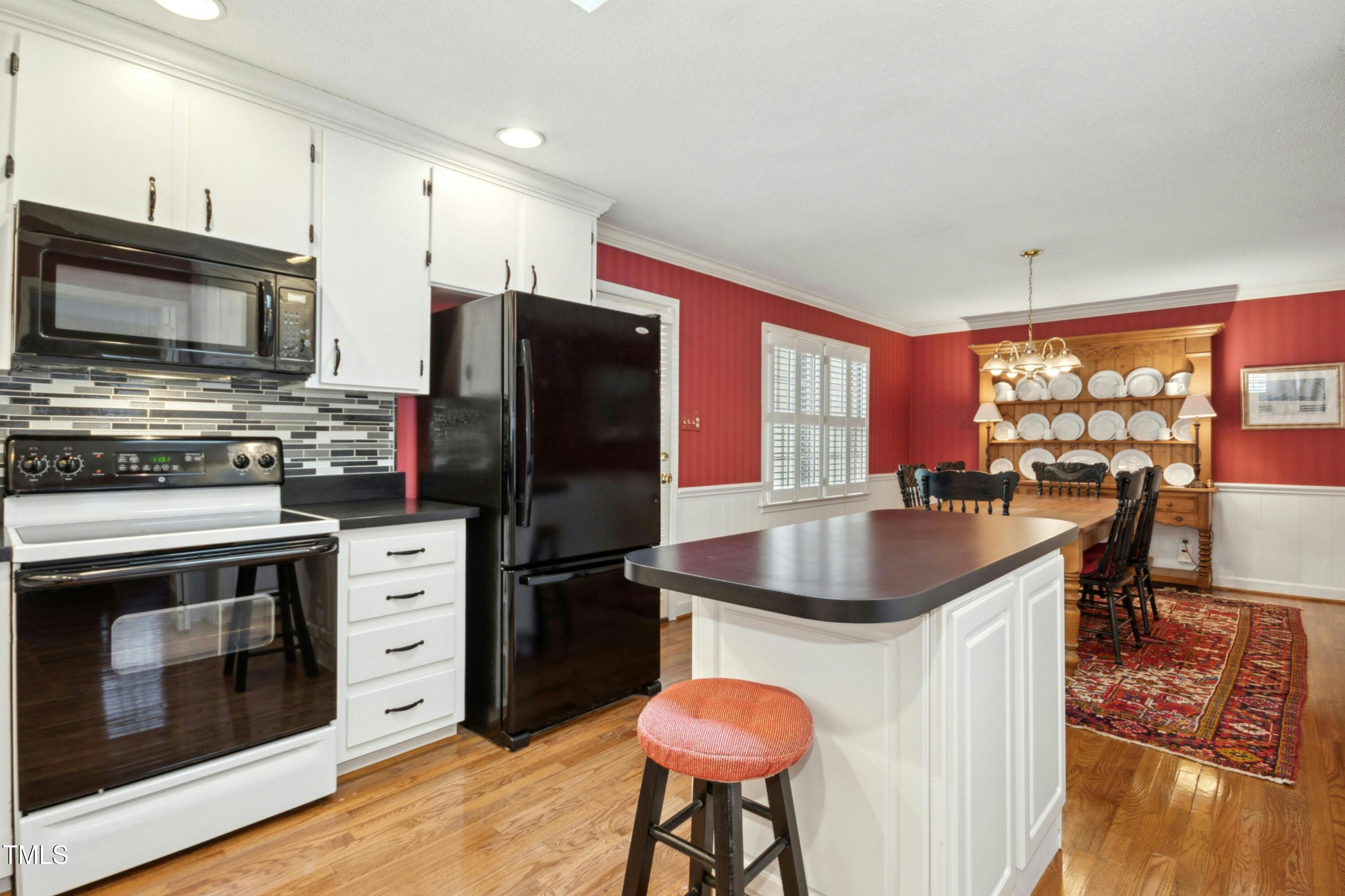 5405 Fireside Drive Raleigh, NC 27609 - Photo 10 of 29 a kitchen with granite countertop a sink stove and refrigerator