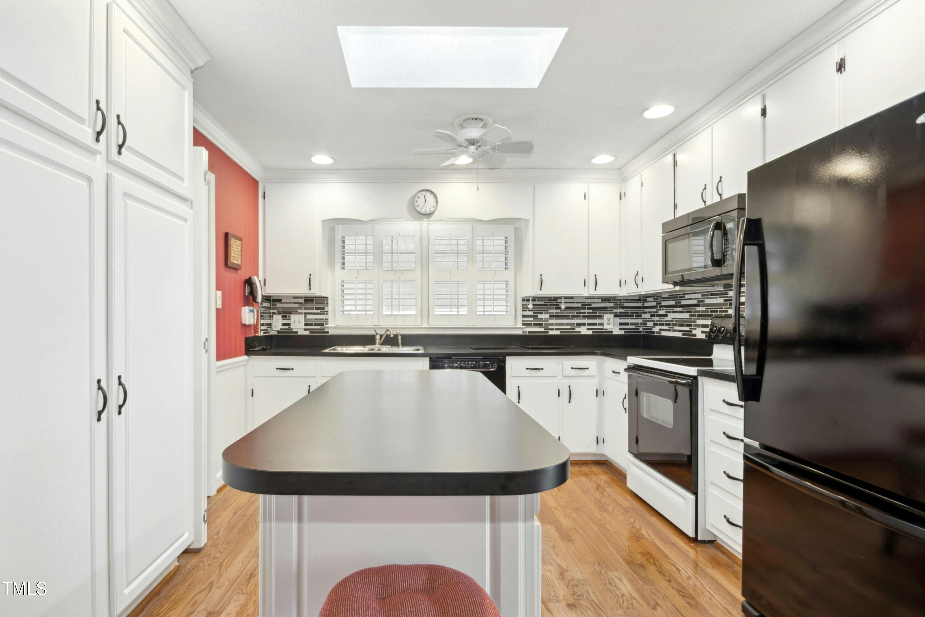 5405 Fireside Drive Raleigh, NC 27609 - Photo 11 of 29 a kitchen with stainless steel appliances a refrigerator sink and stove