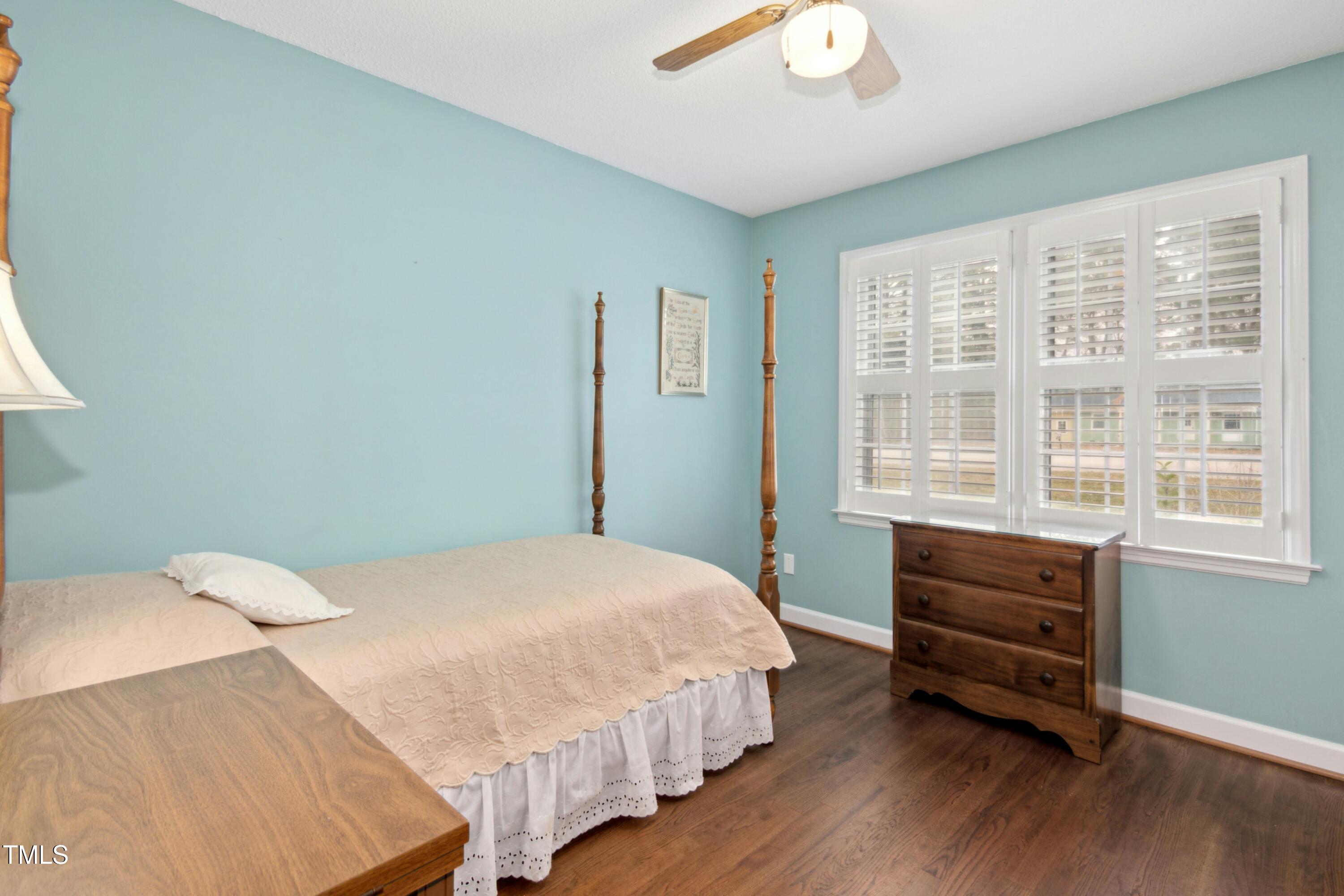 5405 Fireside Drive Raleigh, NC 27609 - Photo 14 of 29 a bedroom with a bed and a window
