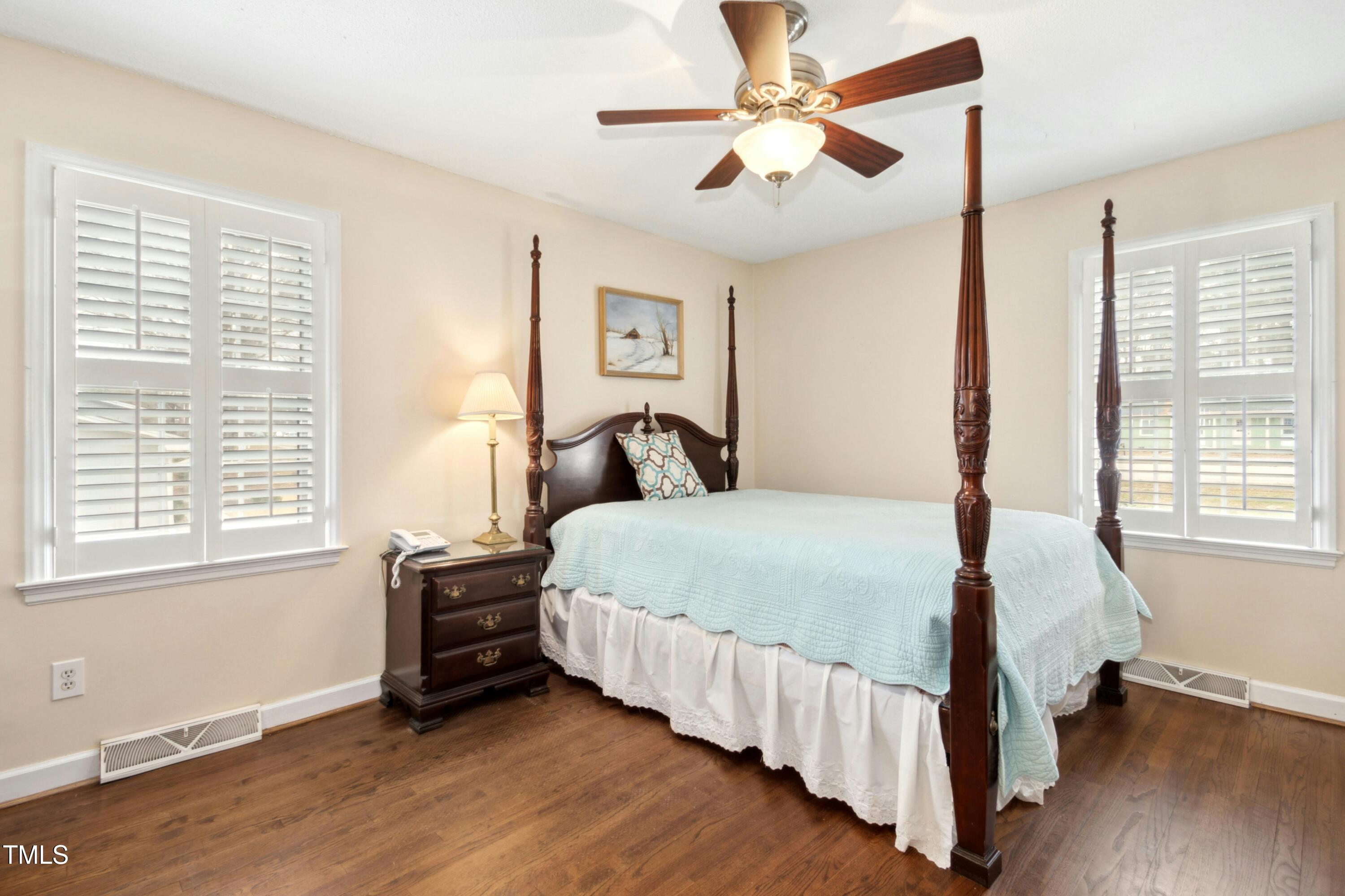 5405 Fireside Drive Raleigh, NC 27609 - Photo 16 of 29 a bedroom with a bed chandelier and a window