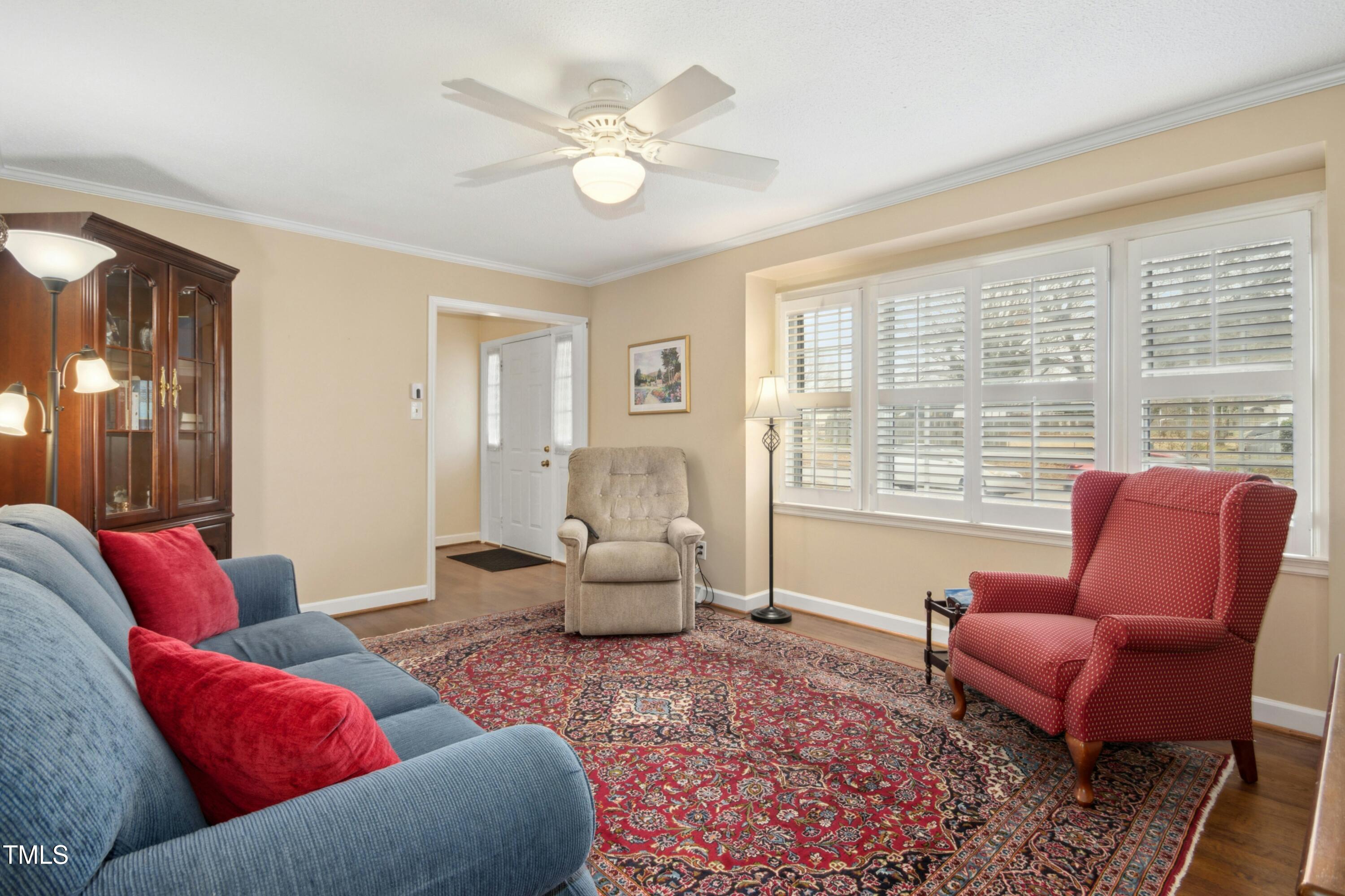 5405 Fireside Drive Raleigh, NC 27609 - Photo 4 of 29 a living room with furniture and a large window