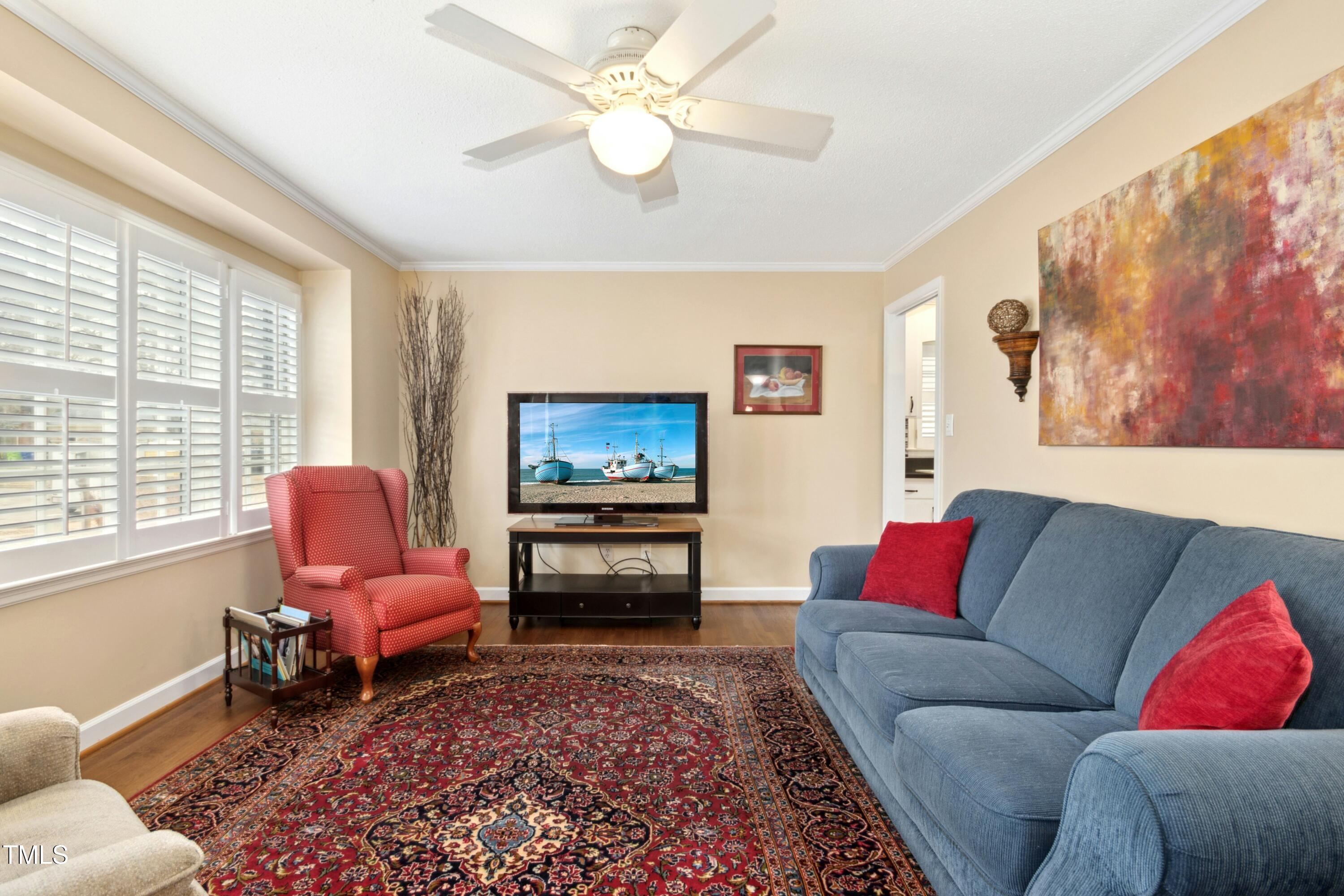 5405 Fireside Drive Raleigh, NC 27609 - Photo 5 of 29 a living room with furniture and a flat screen tv