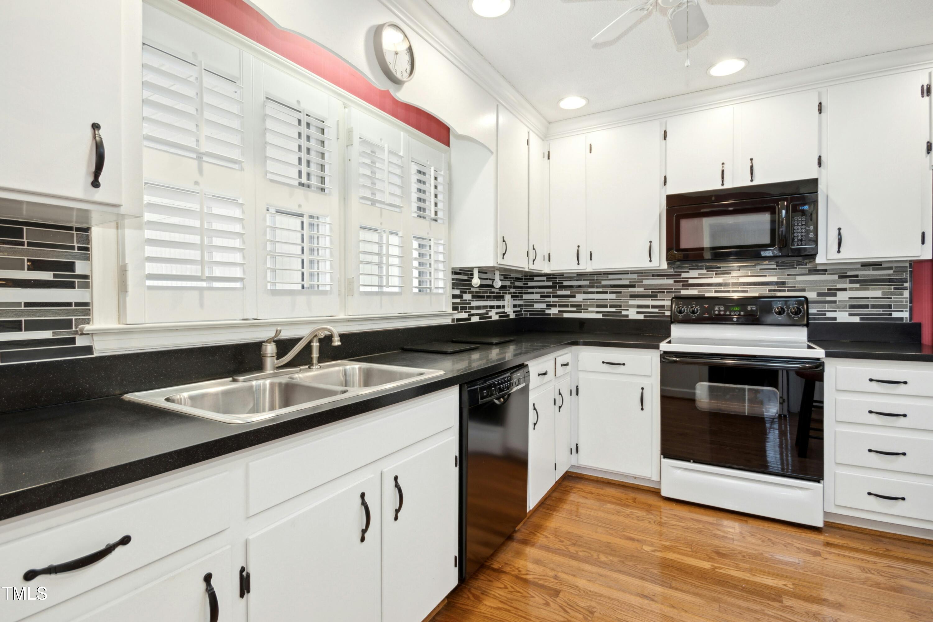 5405 Fireside Drive Raleigh, NC 27609 - Photo 9 of 29 a kitchen with granite countertop a sink a counter top space stainless steel appliances and cabinets