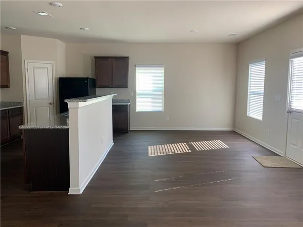 an empty room with wooden floor and a window