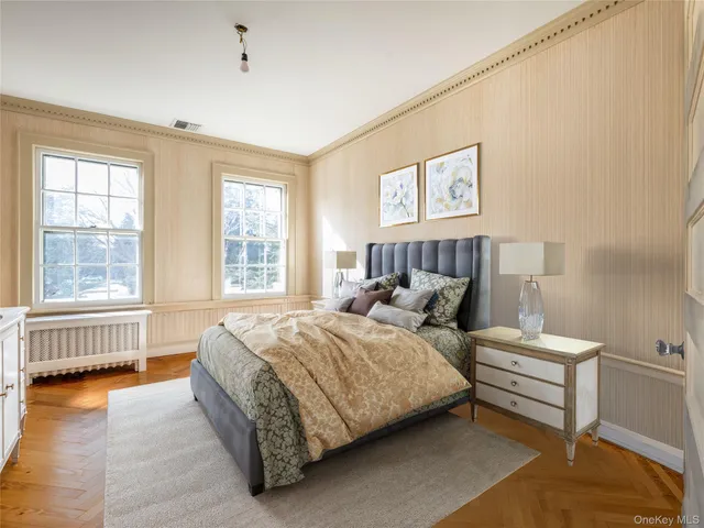 a bedroom with a bed and a large window
