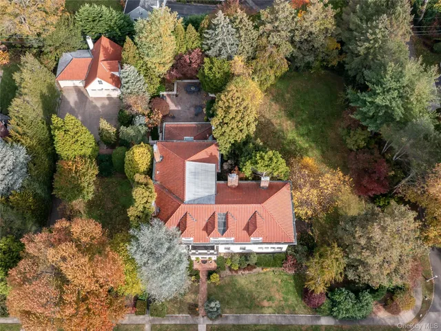 an aerial view of a house with a yard and garden