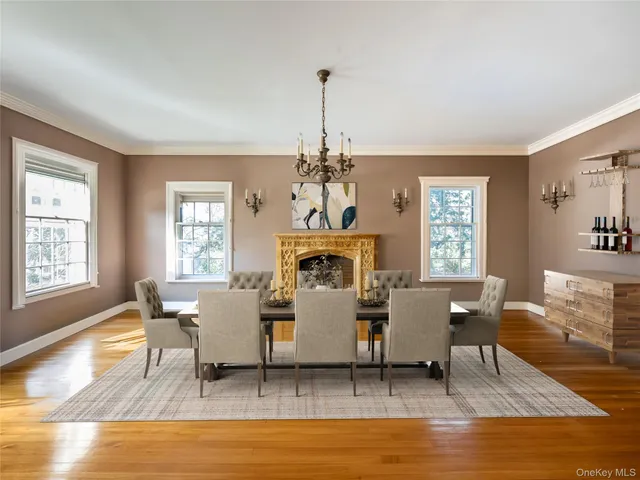 a living room with furniture a fireplace and a chandelier