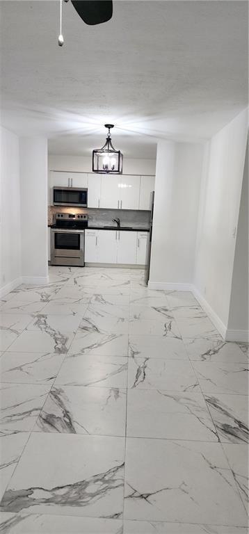 900 Southwest 11th Street, Unit 3 Hallandale Beach, FL 33009 - Photo 13 of 14 a view of kitchen with sink and window