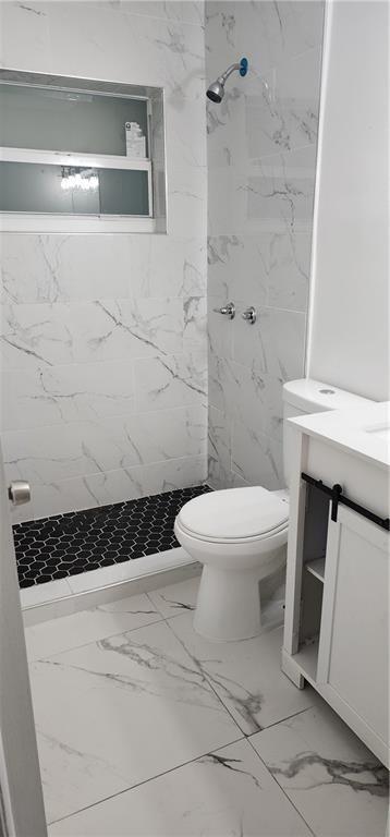 900 Southwest 11th Street, Unit 3 Hallandale Beach, FL 33009 - Photo 14 of 14 a bathroom with a toilet a sink and shower