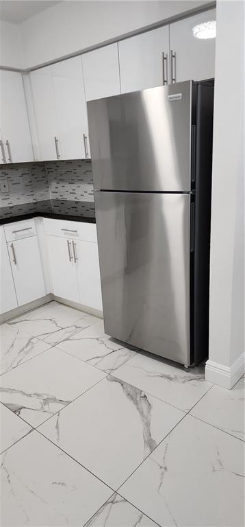 900 Southwest 11th Street, Unit 3 Hallandale Beach, FL 33009 - Photo 9 of 14 a view of a refrigerator in kitchen and dishwasher