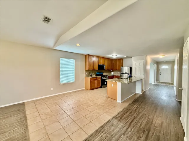 a kitchen with cabinets and wooden floor