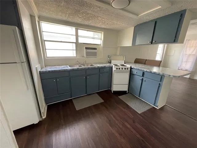 a kitchen with sink cabinets and wooden floor