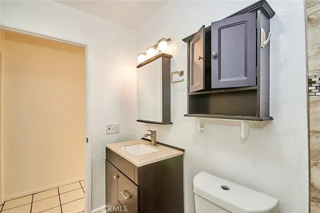 a bathroom with a sink toilet and mirror