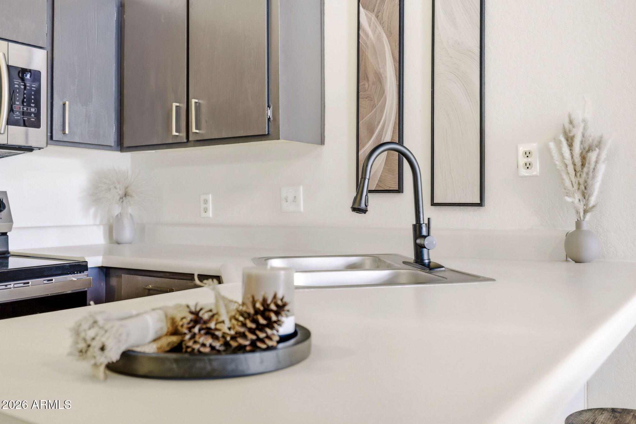 2700 South White Mountain Road, Unit 1025 Show Low, AZ 85901 - Photo 6 of 29 a kitchen with a sink and a stove with wooden floor