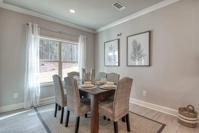 a dining room with furniture a rug and wooden floor