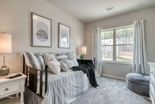 a bedroom with double bed and a window