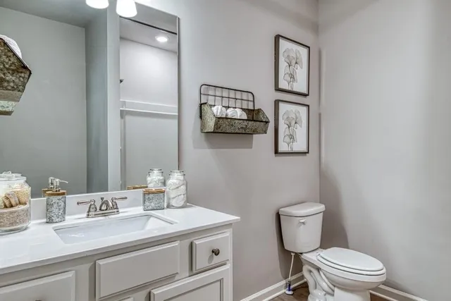 a bathroom with a toilet a sink and mirror