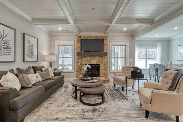 a living room with furniture a flat screen tv and a fireplace