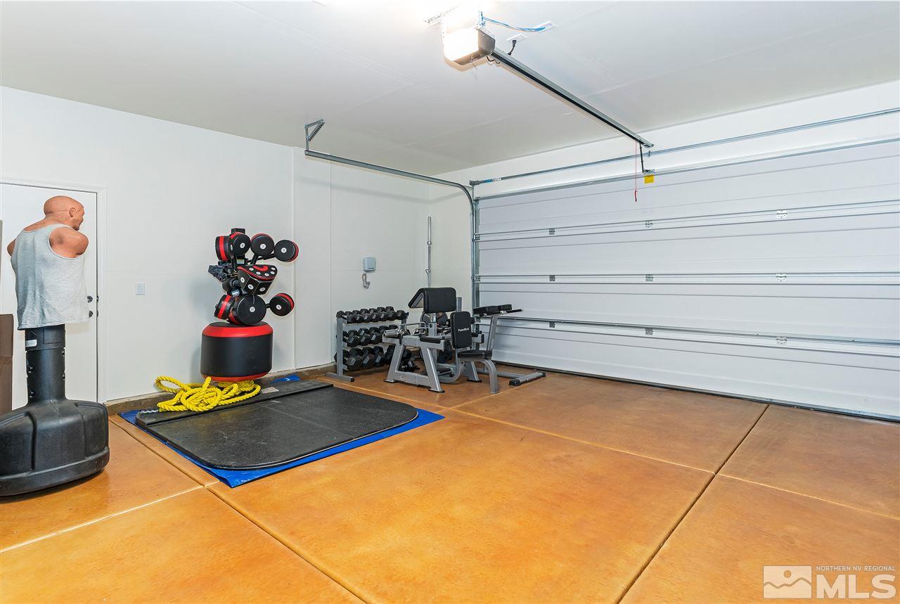 10150 Toltec Court Reno, NV 89521 - Photo 24 of 25 a room with gym equipment and a table