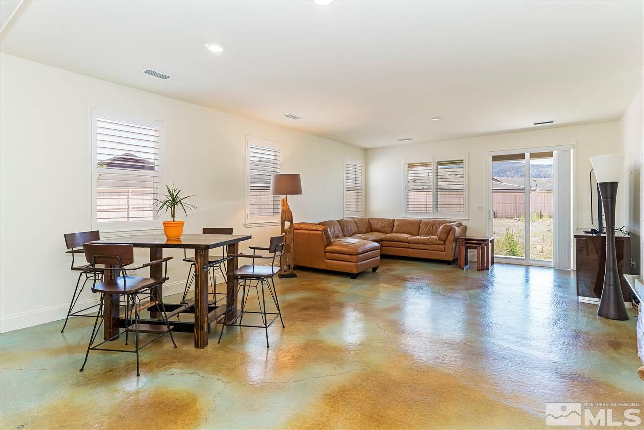 10150 Toltec Court Reno, NV 89521 - Photo 4 of 25 a living room with furniture and a dining table with wooden floor