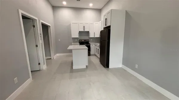 a kitchen that has a cabinets a sink dishwasher a refrigerator and a stove