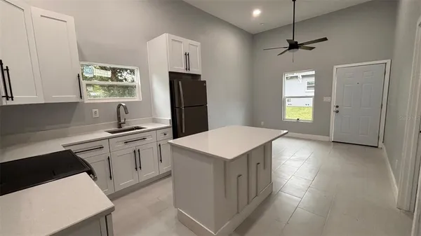 a kitchen with a refrigerator sink and stove