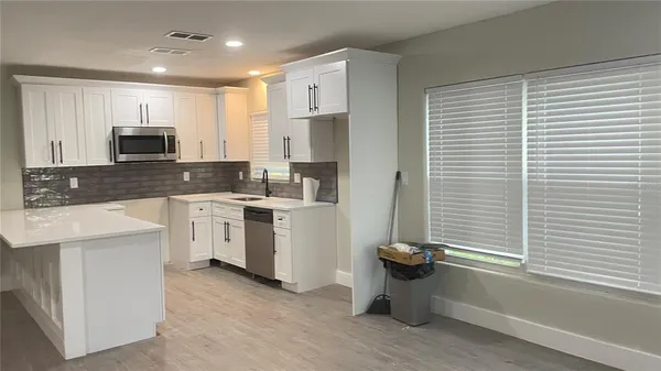 a kitchen with a sink cabinets and appliances