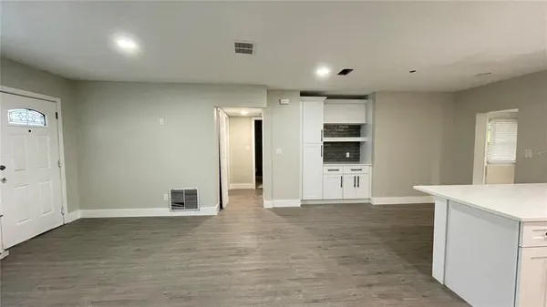 an empty room with closet and windows