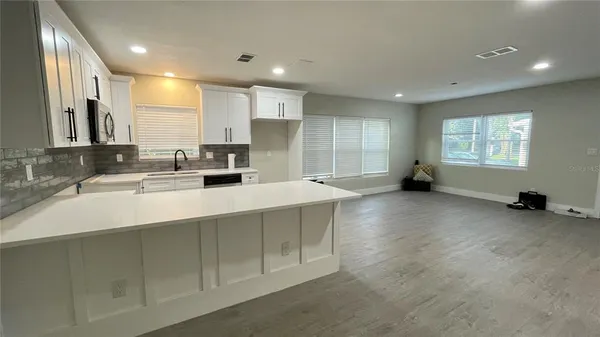 a kitchen with a sink and a large window