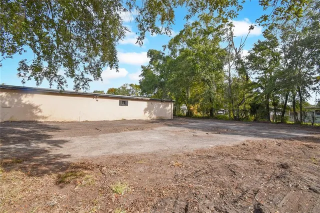 a view of a house with a tree in the background