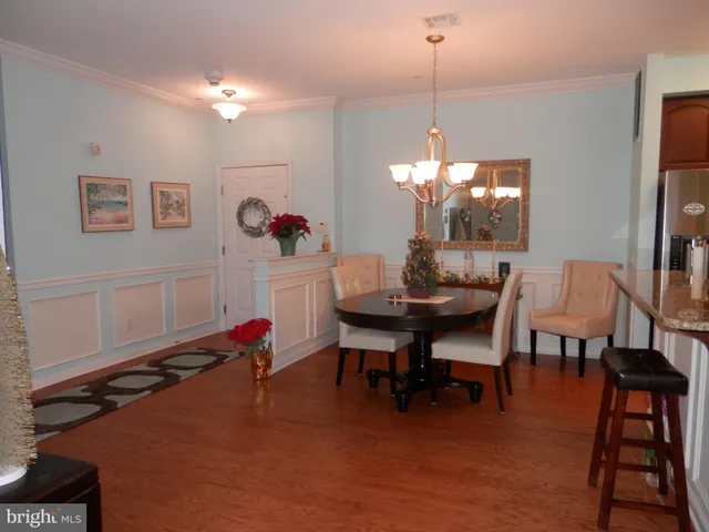 a living room with furniture and a dining table with kitchen view