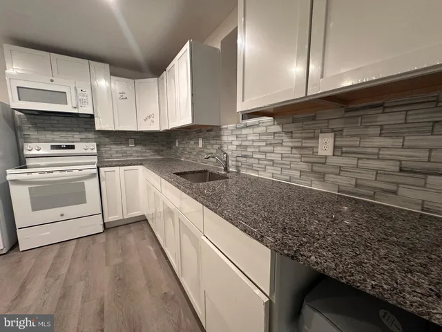 a kitchen with a sink and cabinets