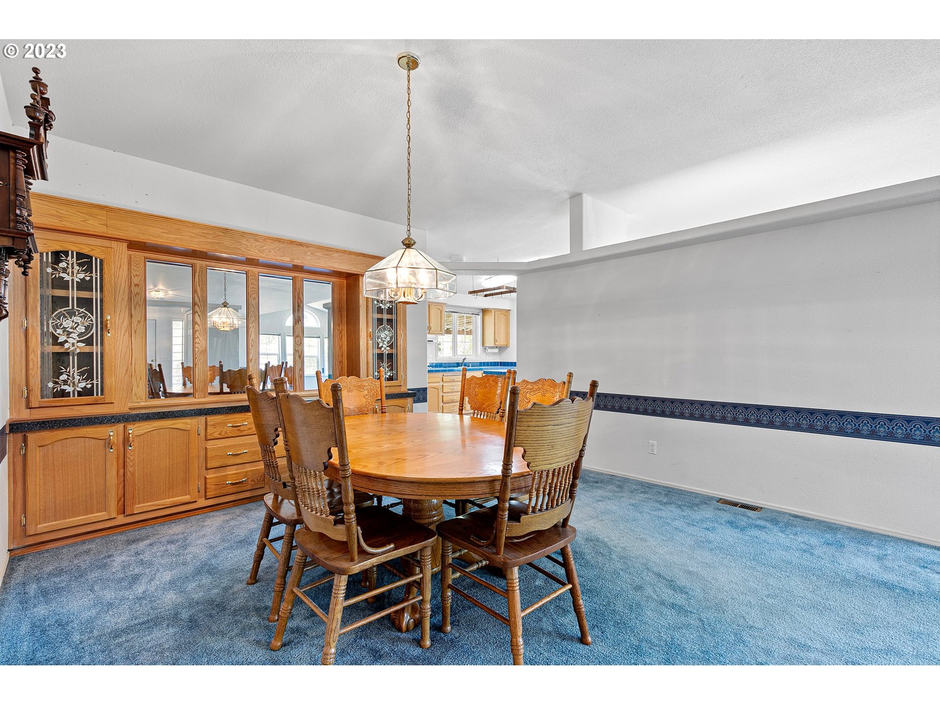 35796 Enterprise Road Creswell, OR 97426 - Photo 14 of 44 a dining room with furniture a chandelier and wooden floor