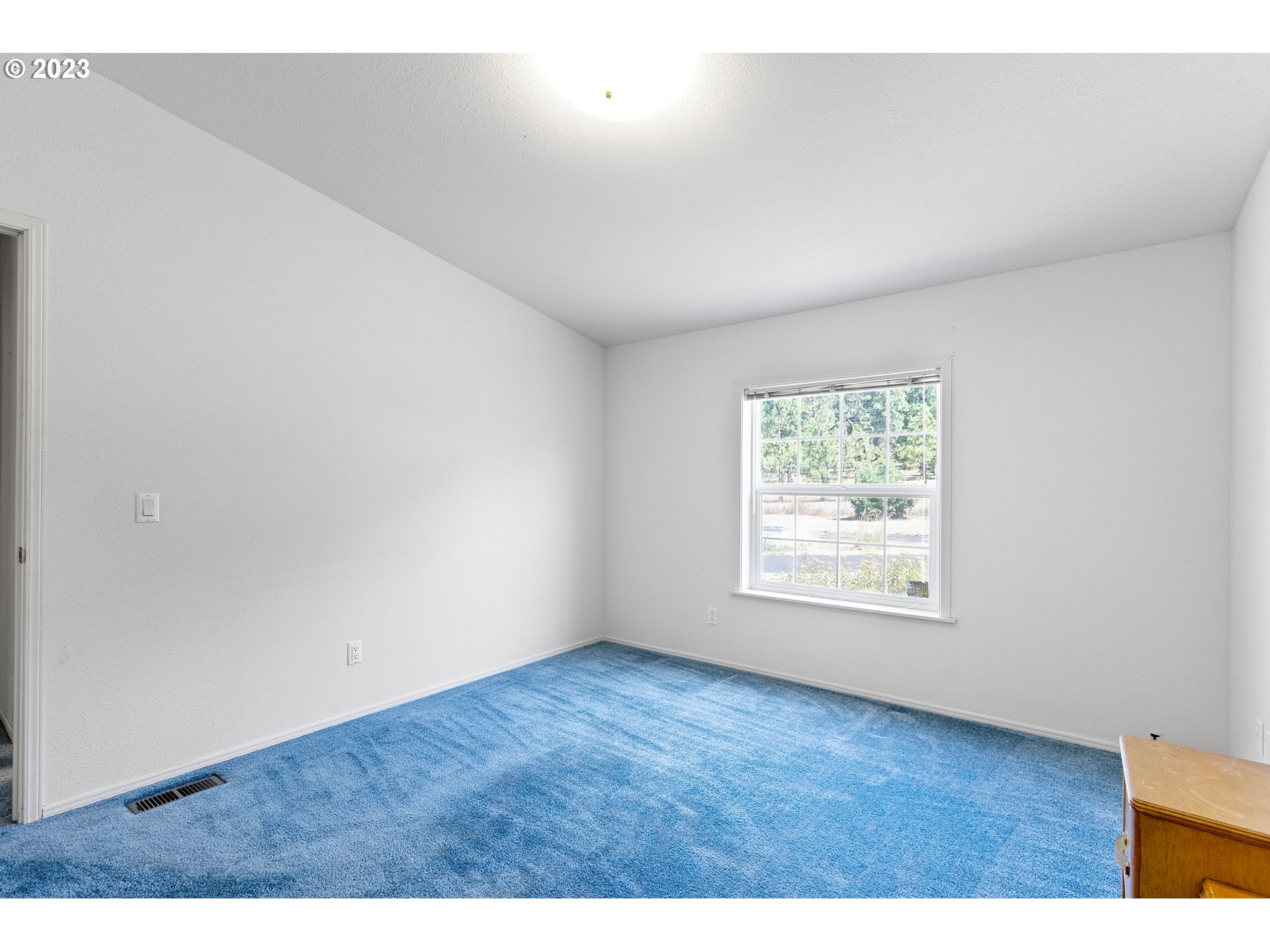 35796 Enterprise Road Creswell, OR 97426 - Photo 23 of 44 a view of an empty room with wooden floor and a window