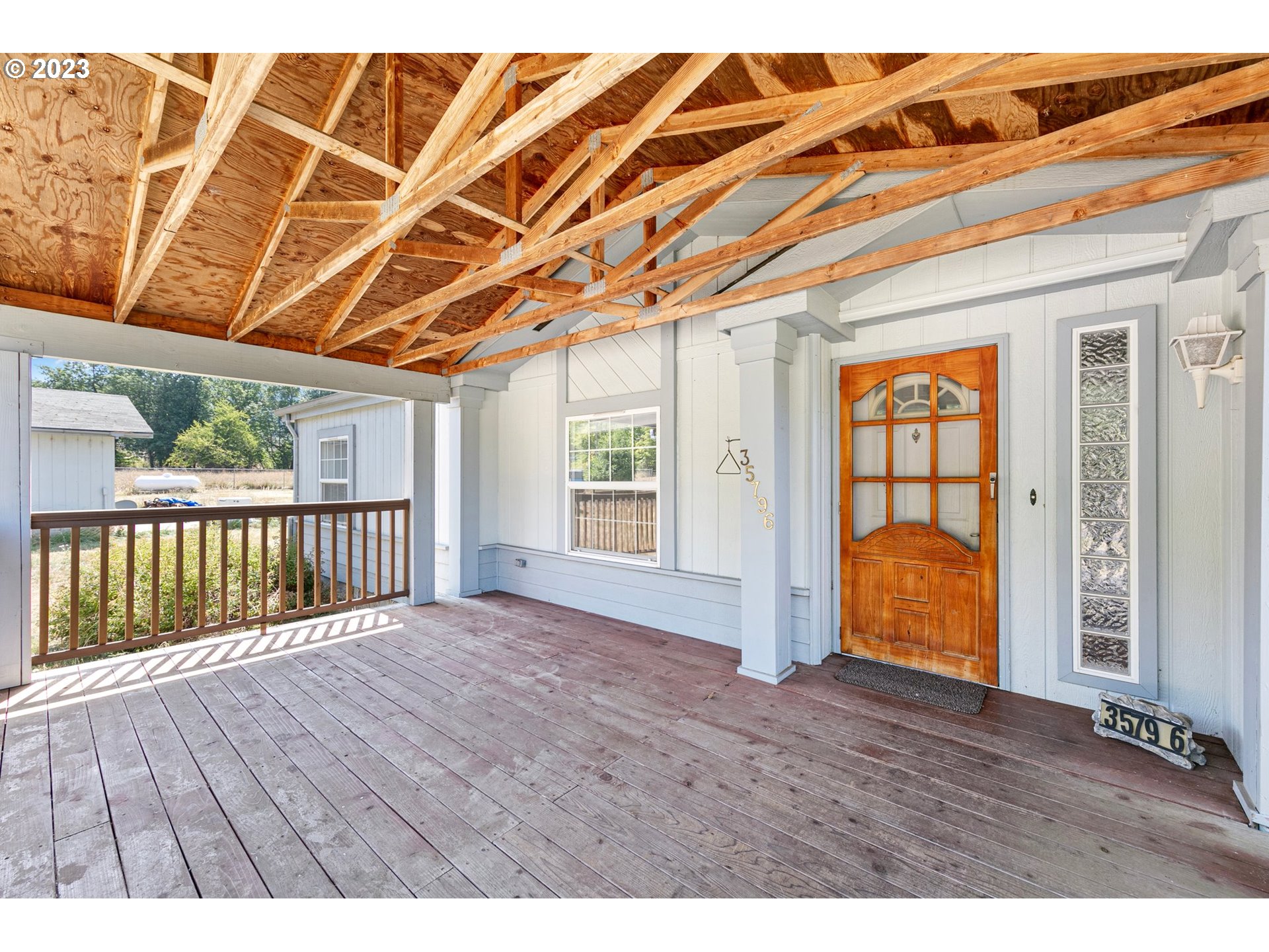 35796 Enterprise Road Creswell, OR 97426 - Photo 3 of 44 a view of an empty room with wooden floor and windows