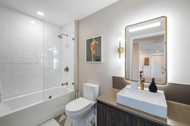 a bathroom with a mirror and a glass shower door