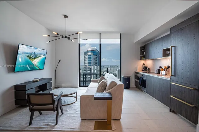 a living room with furniture and kitchen view