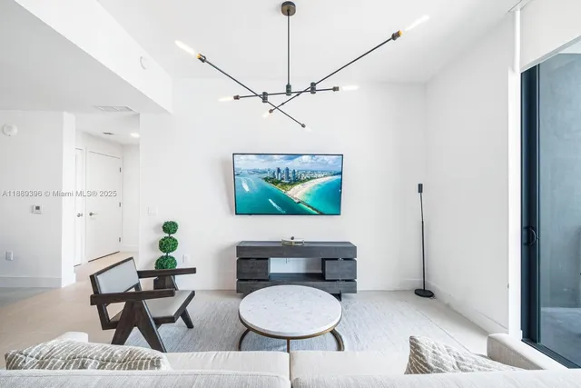 a living room with furniture and a dining table with wooden floor