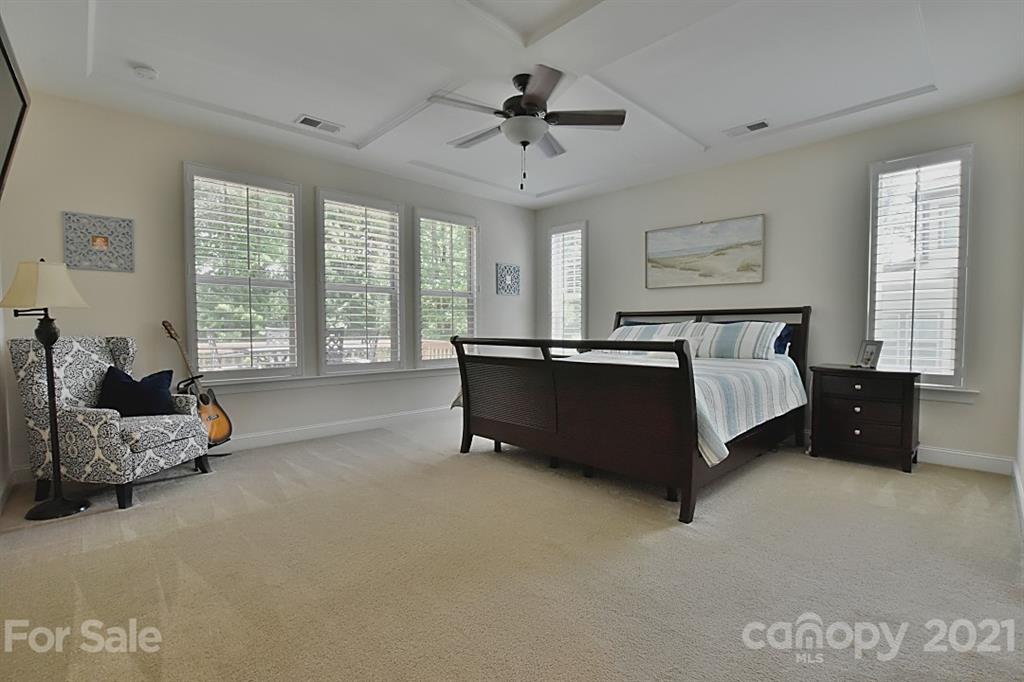 922 Castlewatch Drive Fort Mill, SC 29708 - Photo 12 of 38 a spacious bedroom with a bed and a couch