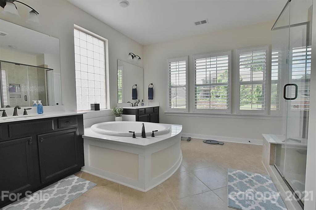 922 Castlewatch Drive Fort Mill, SC 29708 - Photo 13 of 38 a bathroom with a sink double vanity mirror and tub