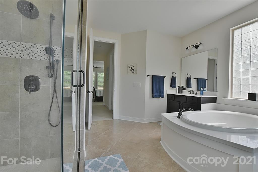 922 Castlewatch Drive Fort Mill, SC 29708 - Photo 14 of 38 a bathroom with a tub sink and shower