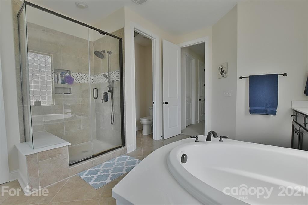 922 Castlewatch Drive Fort Mill, SC 29708 - Photo 15 of 38 a bathroom with a tub a sink and shower